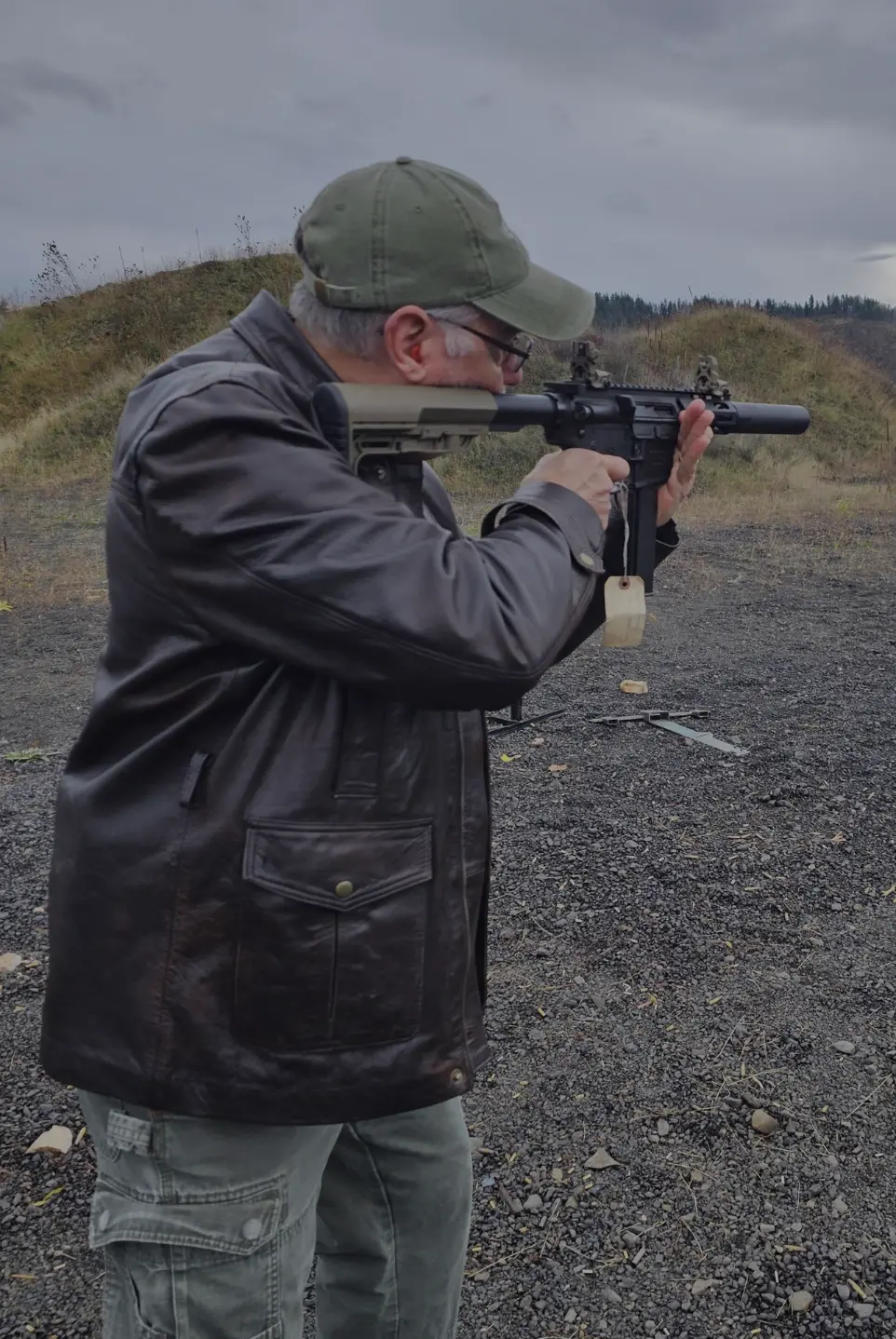 Man wearing black jacket shooting semi automatic rifle