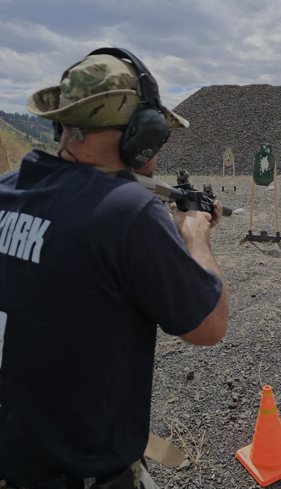 Man in black shirt shooting a firearm