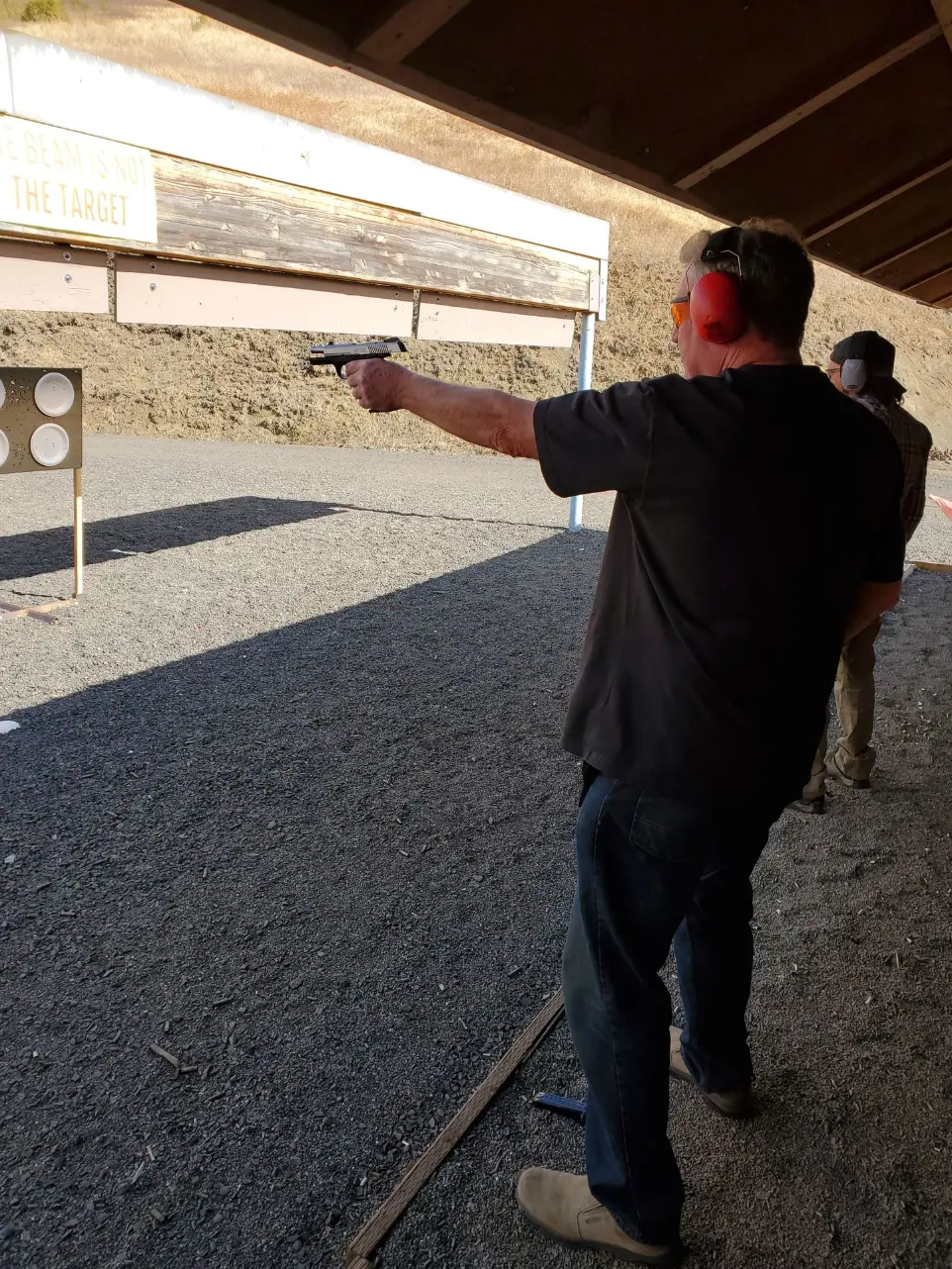 Two men shooting in the range